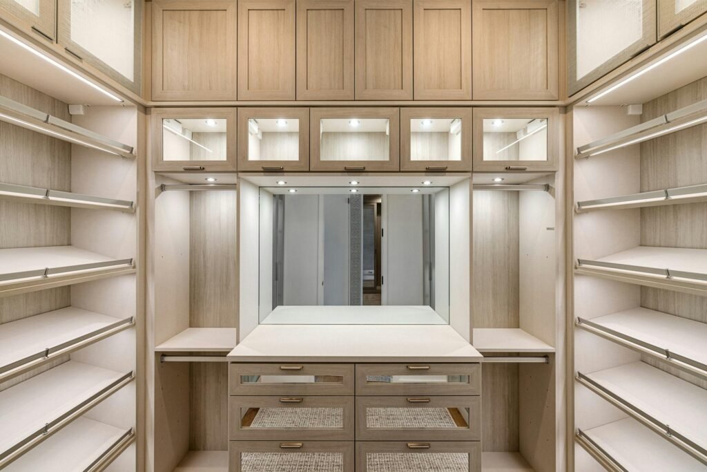 vegetative-roof Spacious walk-in closet with wooden cabinets and ample lighting.